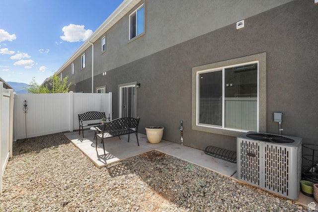 3154 W 1650 N Unit D, Cedar City, UT 84721 - back of property with a fenced backyard, central AC unit, stucco siding, and a patio