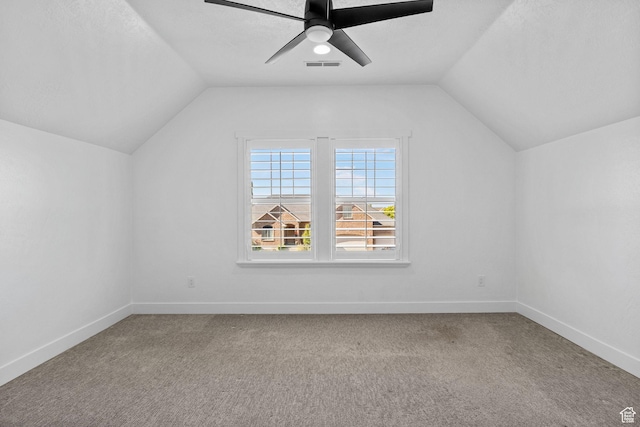 additional living space featuring carpet floors, a ceiling fan, and lofted ceiling