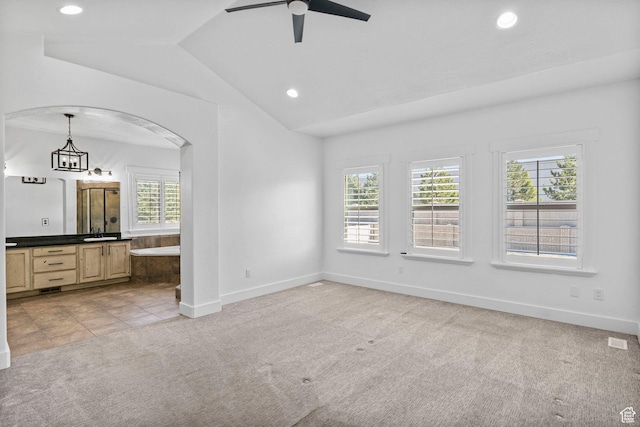 unfurnished bedroom with recessed lighting, multiple windows, vaulted ceiling, and light carpet