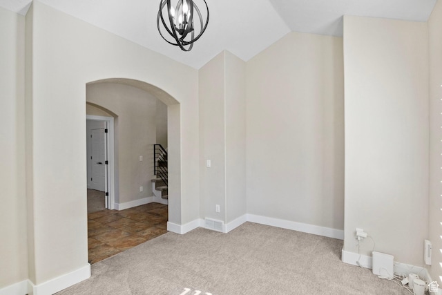 carpeted spare room featuring arched walkways, a chandelier, stairs, baseboards, and lofted ceiling