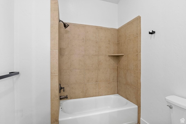 bathroom featuring shower / bathing tub combination and toilet