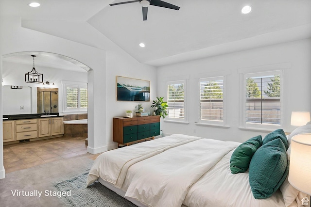 bedroom with light tile patterned flooring, arched walkways, recessed lighting, ensuite bathroom, and lofted ceiling