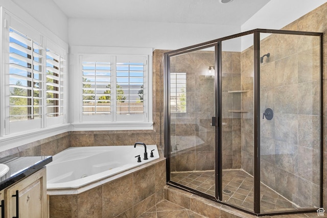 bathroom featuring vanity, a shower stall, and a bath