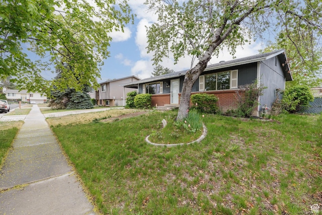 5550 Westside Dr, Kearns, UT 84118 - view of front facade featuring a front yard and brick siding
