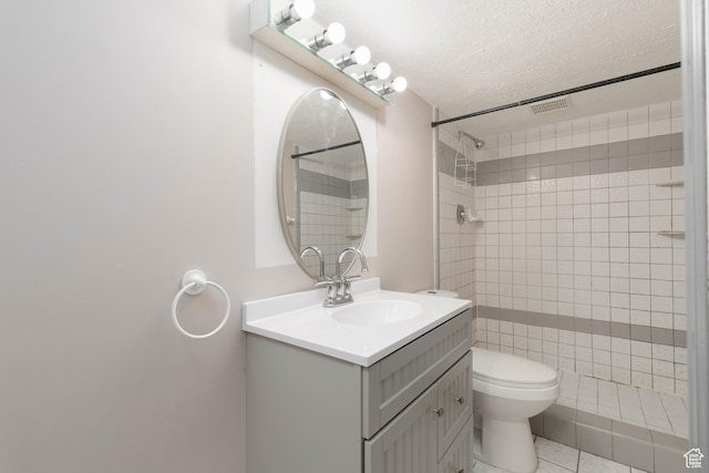 5550 Westside Dr, Kearns, UT 84118 - full bath featuring a textured ceiling, visible vents, vanity, toilet, and tiled shower