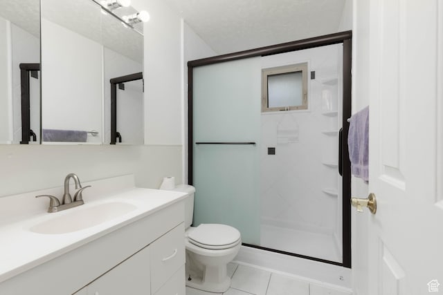 5550 Westside Dr, Kearns, UT 84118 - full bathroom featuring vanity, toilet, tile patterned floors, and a stall shower