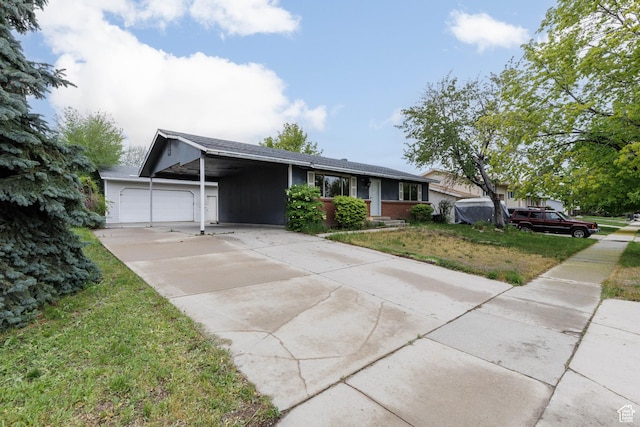 5550 Westside Dr, Kearns, UT 84118 - ranch-style house with a carport, an attached garage, concrete driveway, and a front yard