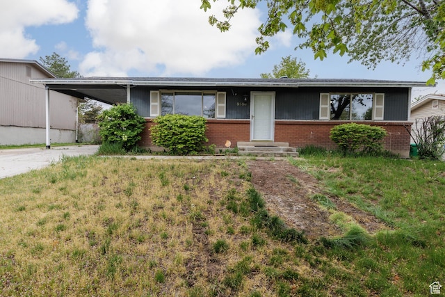 5550 Westside Dr, Kearns, UT 84118 - ranch-style house featuring brick siding, an attached carport, and concrete driveway