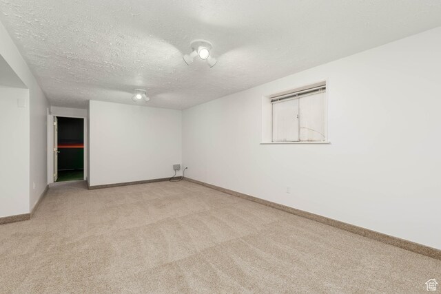 5550 Westside Dr, Kearns, UT 84118 - empty room with light colored carpet, a textured ceiling, and baseboards