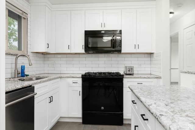 5550 Westside Dr, Kearns, UT 84118 - kitchen with white cabinets, tasteful backsplash, light stone counters, a sink, and black appliances