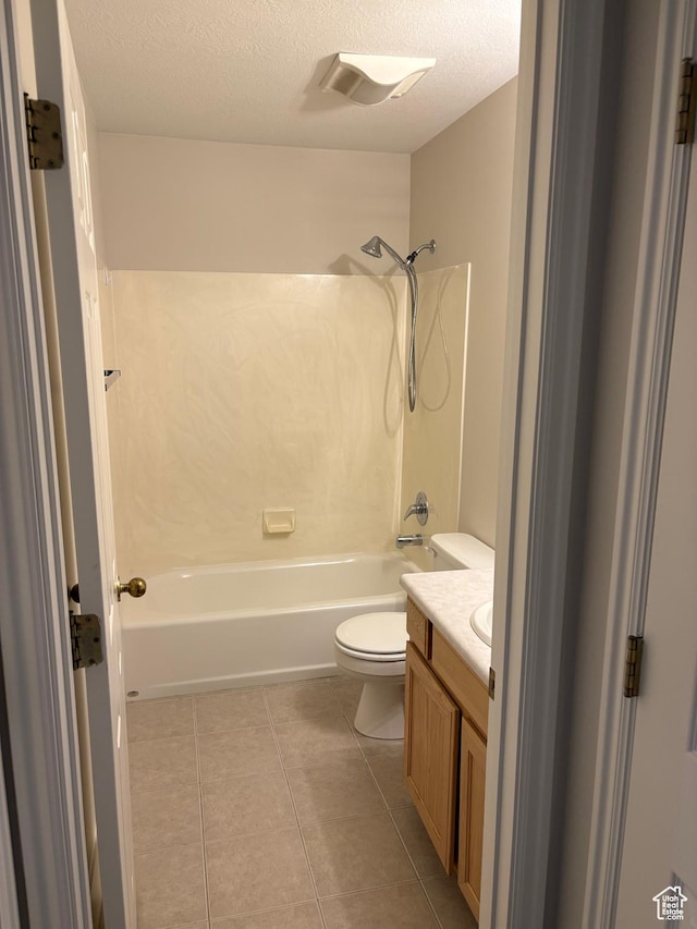 bathroom featuring a textured ceiling, tile patterned flooring, bathtub / shower combination, vanity, and toilet