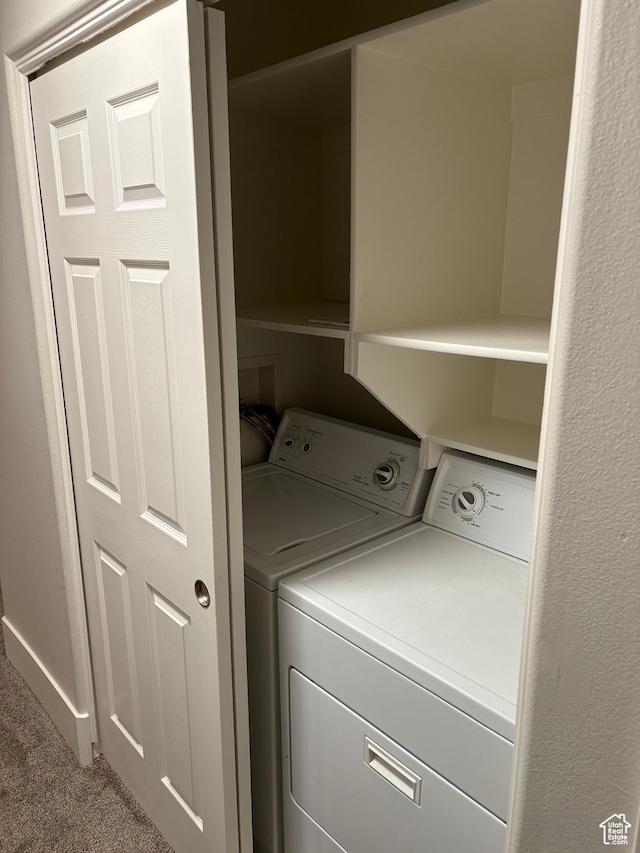 laundry room featuring carpet floors, laundry area, and washer and clothes dryer