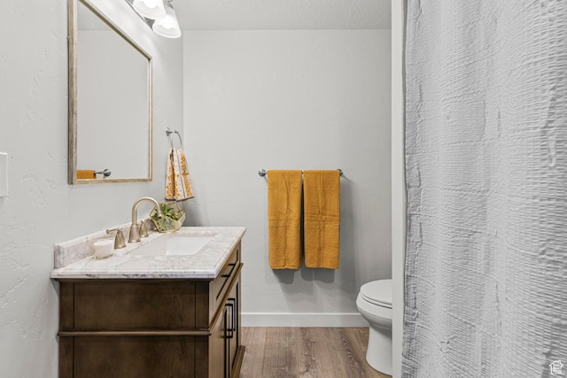 5829 N Goldfinch Ln, Stansbury Park, UT 84074 - bathroom featuring vanity, toilet, a shower with shower curtain, baseboards, and wood finished floors