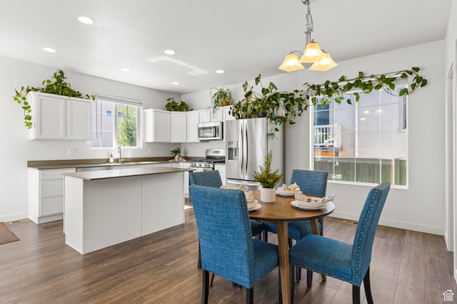 5829 N Goldfinch Ln, Stansbury Park, UT 84074 - dining area featuring dark wood-type flooring, recessed lighting, and baseboards