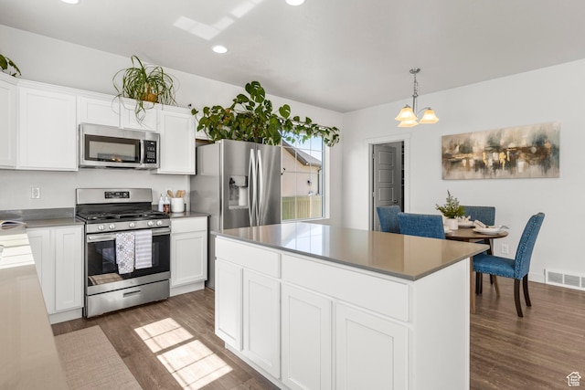5829 N Goldfinch Ln, Stansbury Park, UT 84074 - kitchen with white cabinets, dark wood-style flooring, stainless steel appliances, recessed lighting, and visible vents