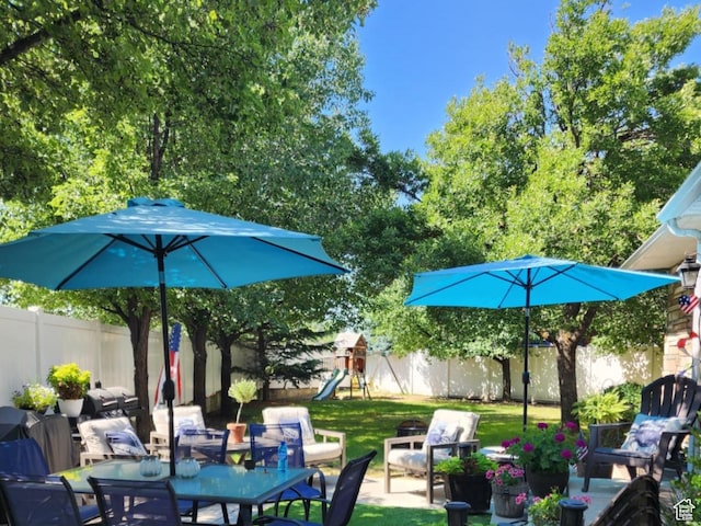 6439 S 1940 E, Murray, UT 84121 - view of patio with a playground, outdoor dining space, and a fenced backyard