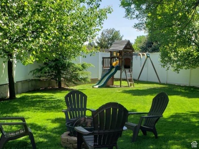 6439 S 1940 E, Murray, UT 84121 - view of yard with a playground, a fenced backyard, and a fire pit