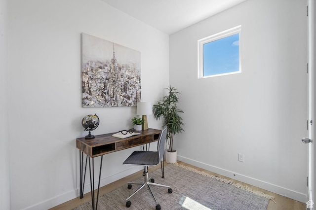office featuring baseboards and wood finished floors