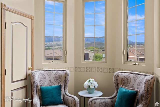sitting room with plenty of natural light and a mountain view