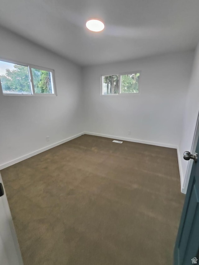 3112 S 3780 W, West Valley City, UT 84120 - unfurnished room featuring healthy amount of natural light, dark colored carpet, and baseboards
