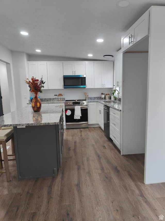 3112 S 3780 W, West Valley City, UT 84120 - kitchen featuring stainless steel appliances, a sink, light stone countertops, white cabinetry, and recessed lighting