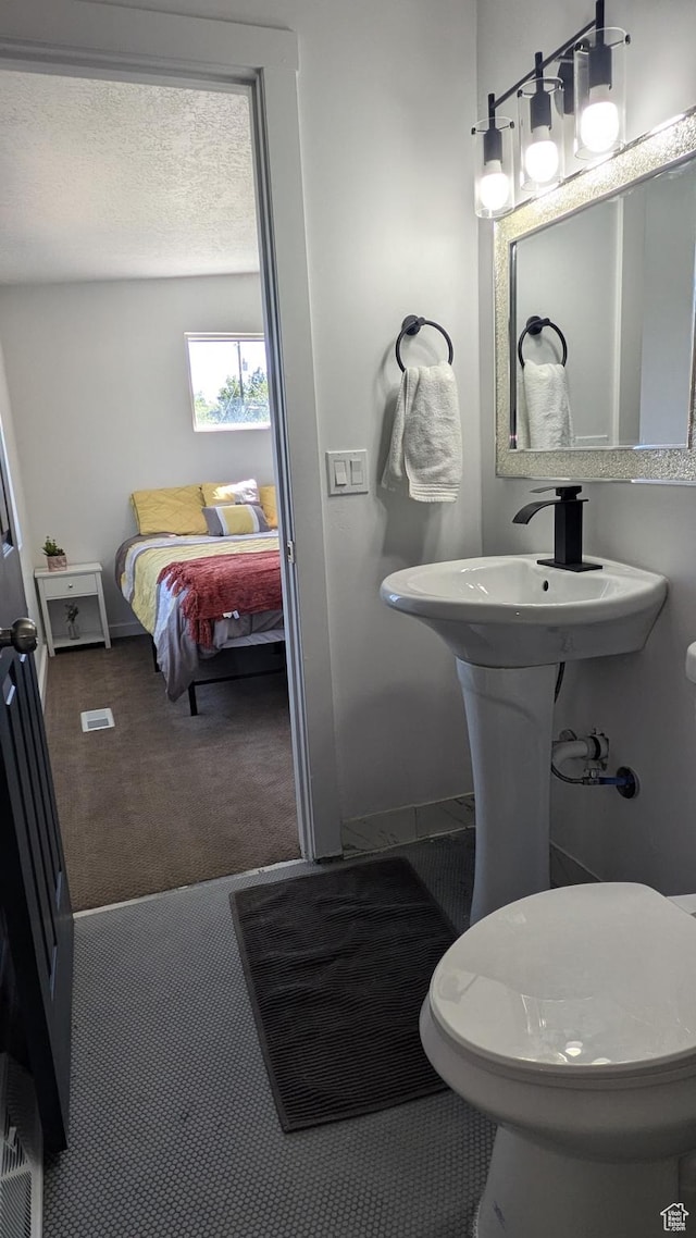 3112 S 3780 W, West Valley City, UT 84120 - ensuite bathroom featuring baseboards and toilet