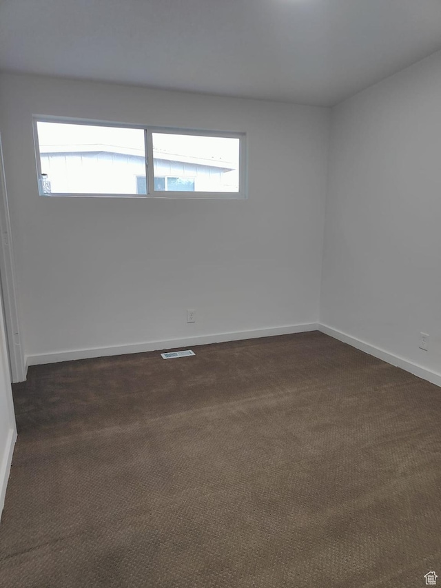 3112 S 3780 W, West Valley City, UT 84120 - spare room with plenty of natural light, dark colored carpet, and baseboards