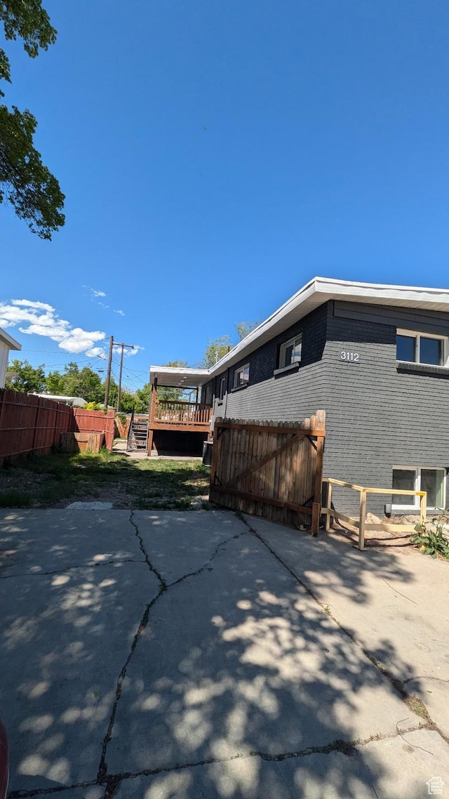 3112 S 3780 W, West Valley City, UT 84120 - view of home's exterior with brick siding, a deck, and a patio area