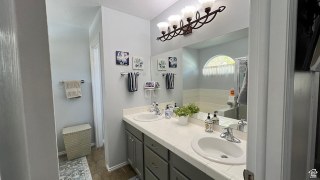 5026 S 1150 E, South Ogden, UT 84403 - bathroom with a sink, an inviting chandelier, double vanity, and a bath