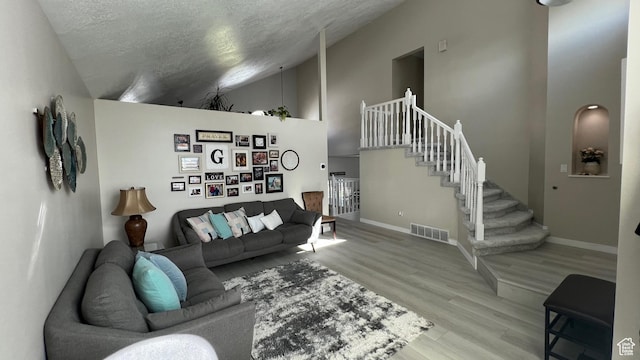 5026 S 1150 E, South Ogden, UT 84403 - living area featuring a textured ceiling, visible vents, wood finished floors, baseboards, and stairs