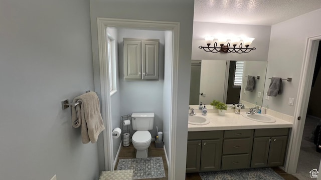 5026 S 1150 E, South Ogden, UT 84403 - bathroom featuring a sink, toilet, double vanity, and a chandelier