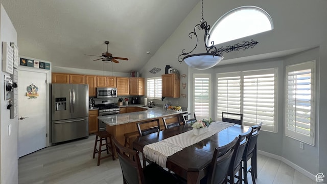 5026 S 1150 E, South Ogden, UT 84403 - dining room featuring high vaulted ceiling, ceiling fan, baseboards, and light wood-type flooring