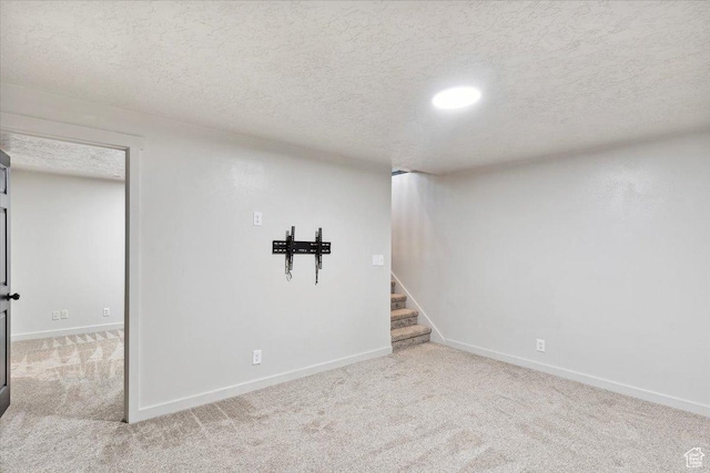 5782 Redwood Ln, South Ogden, UT 84403 - finished below grade area with carpet floors, a textured ceiling, baseboards, and stairs