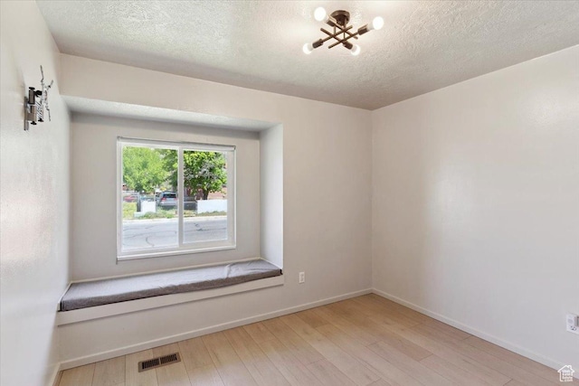 5782 Redwood Ln, South Ogden, UT 84403 - spare room featuring baseboards, a textured ceiling, wood finished floors, and visible vents