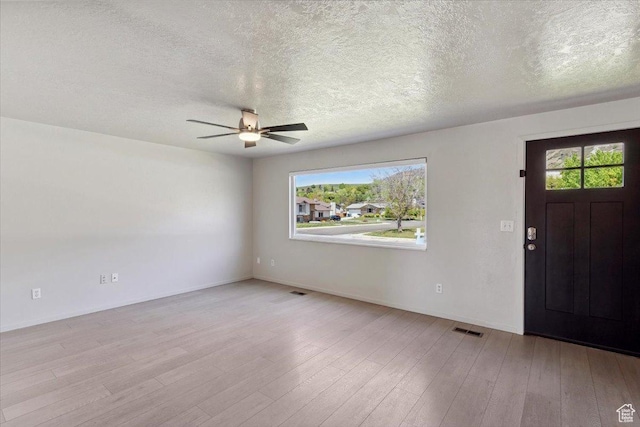 5782 Redwood Ln, South Ogden, UT 84403 - foyer featuring wood finished floors, ceiling fan, a textured ceiling, and visible vents