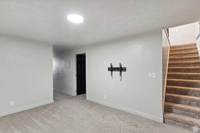 5782 Redwood Ln, South Ogden, UT 84403 - unfurnished room with a textured ceiling, baseboards, light colored carpet, and stairway