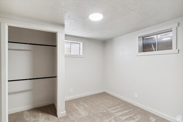 5782 Redwood Ln, South Ogden, UT 84403 - below grade area featuring baseboards, carpet, and a textured ceiling