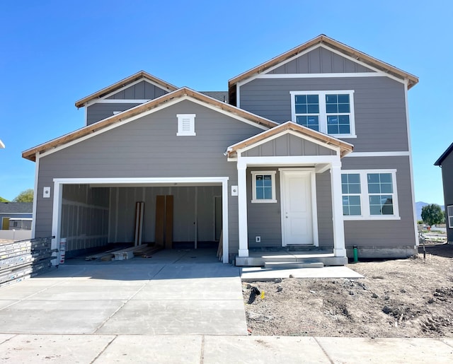 view of front of house with a garage, concrete driveway, and board and batten siding