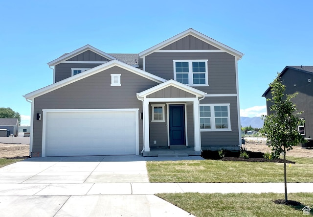 2185 W 1960th St N, Lehi, UT 84043 - view of front facade with board and batten siding, an attached garage, driveway, and a front lawn