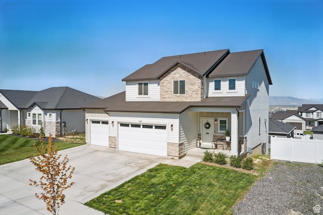 1147 N Carriage Ln, Spanish Fork, UT 84660 - traditional home with a front lawn, fence, covered porch, stone siding, and concrete driveway
