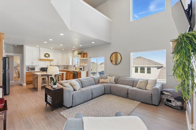 1147 N Carriage Ln, Spanish Fork, UT 84660 - living area with recessed lighting, light wood finished floors, and a towering ceiling