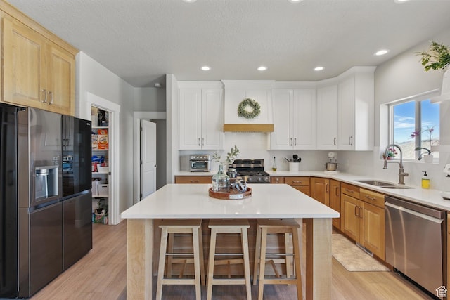 1147 N Carriage Ln, Spanish Fork, UT 84660 - kitchen with a sink, light countertops, stainless steel appliances, and light wood-type flooring