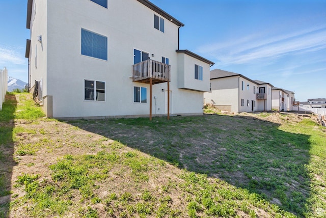 1147 N Carriage Ln, Spanish Fork, UT 84660 - rear view of house with a balcony, stucco siding, and a yard
