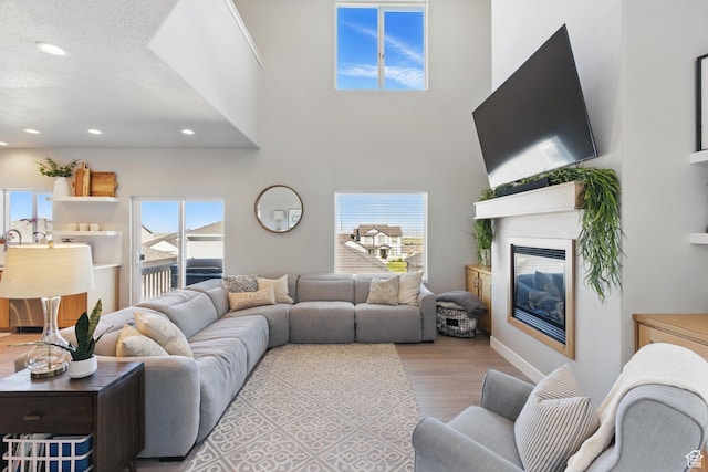 1147 N Carriage Ln, Spanish Fork, UT 84660 - living area with recessed lighting, a glass covered fireplace, and wood finished floors
