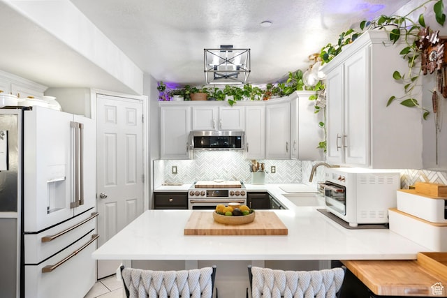 929 W 670 S Unit 8, Pleasant Grove, UT 84062 - kitchen with decorative backsplash, a peninsula, light countertops, a sink, and appliances with stainless steel finishes