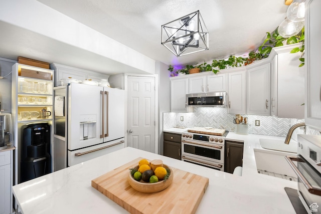 929 W 670 S Unit 8, Pleasant Grove, UT 84062 - kitchen featuring light countertops, decorative backsplash, white cabinetry, and high quality appliances