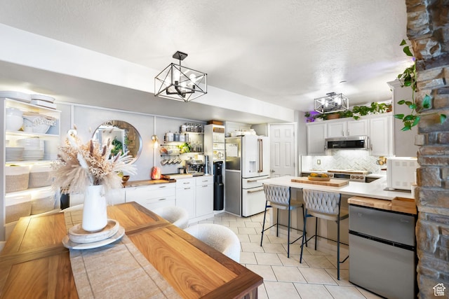 929 W 670 S Unit 8, Pleasant Grove, UT 84062 - kitchen featuring backsplash, white cabinetry, appliances with stainless steel finishes, and a chandelier