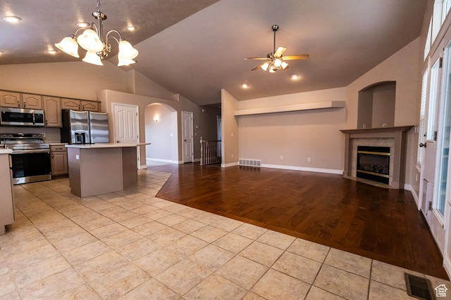 4902 W Pine Laurel Ln, West Jordan, UT 84081 - kitchen featuring visible vents, open floor plan, light countertops, arched walkways, and appliances with stainless steel finishes