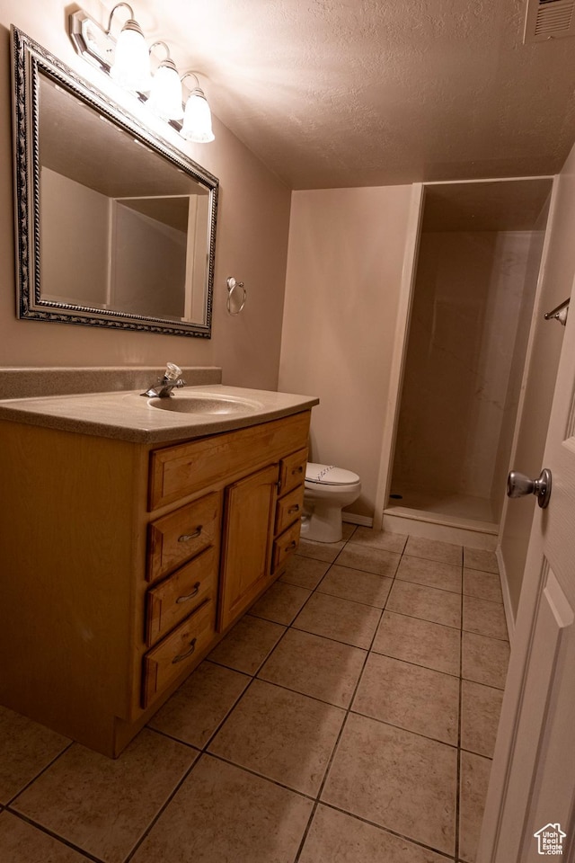 4902 W Pine Laurel Ln, West Jordan, UT 84081 - bathroom featuring vanity, toilet, walk in shower, a textured ceiling, and tile patterned floors