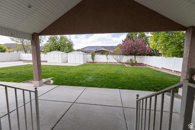 4902 W Pine Laurel Ln, West Jordan, UT 84081 - view of patio featuring a storage shed, an outdoor structure, and a fenced backyard